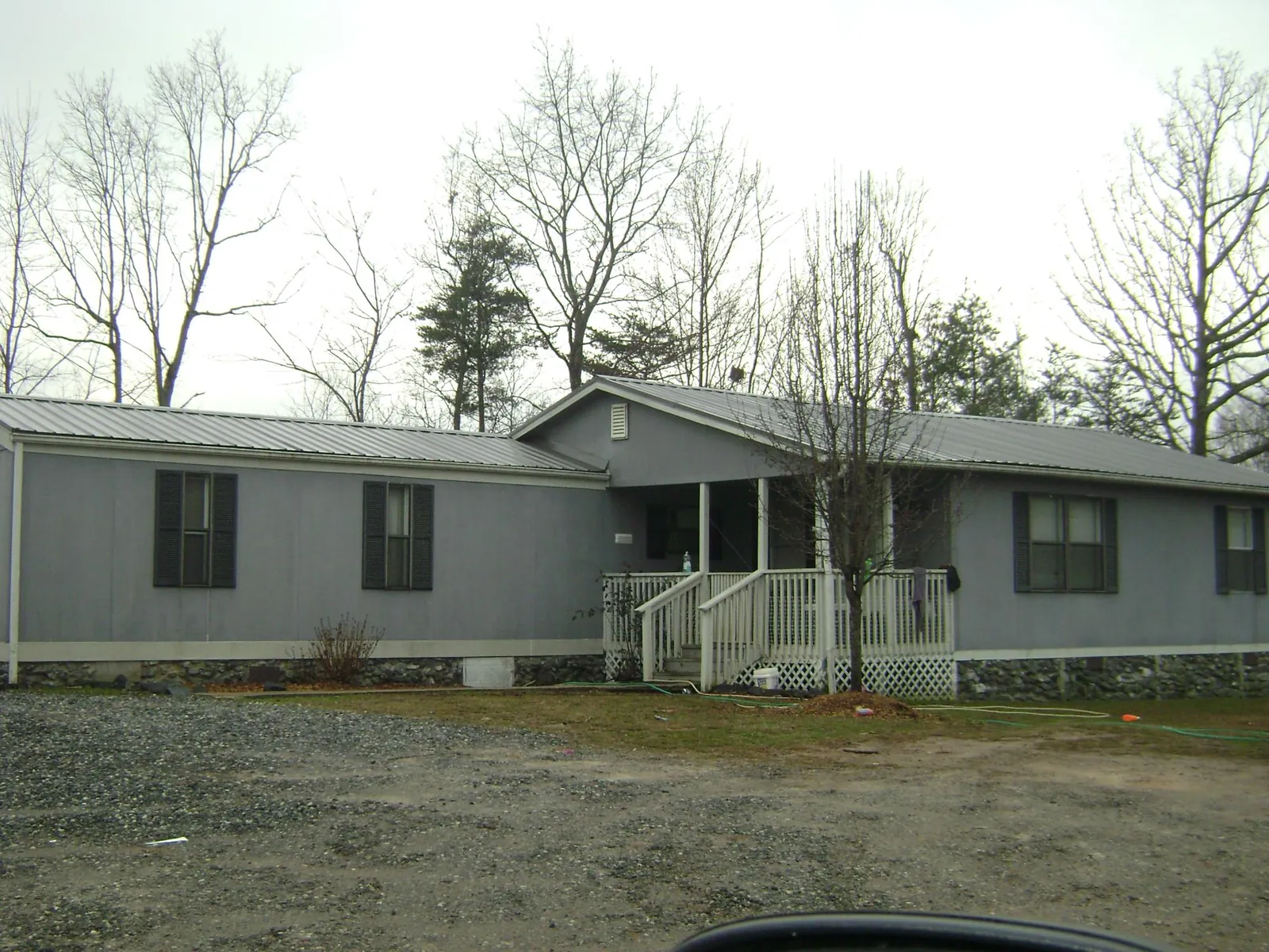 Metal roof over a manufactured home with a covered front porch in Glenwood